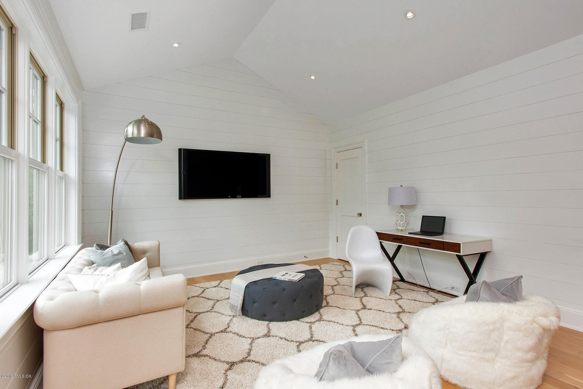 51 Sheep Hill Road Riverside, CT 06878 - Photo 16 of 36 a living room with furniture and a flat screen tv