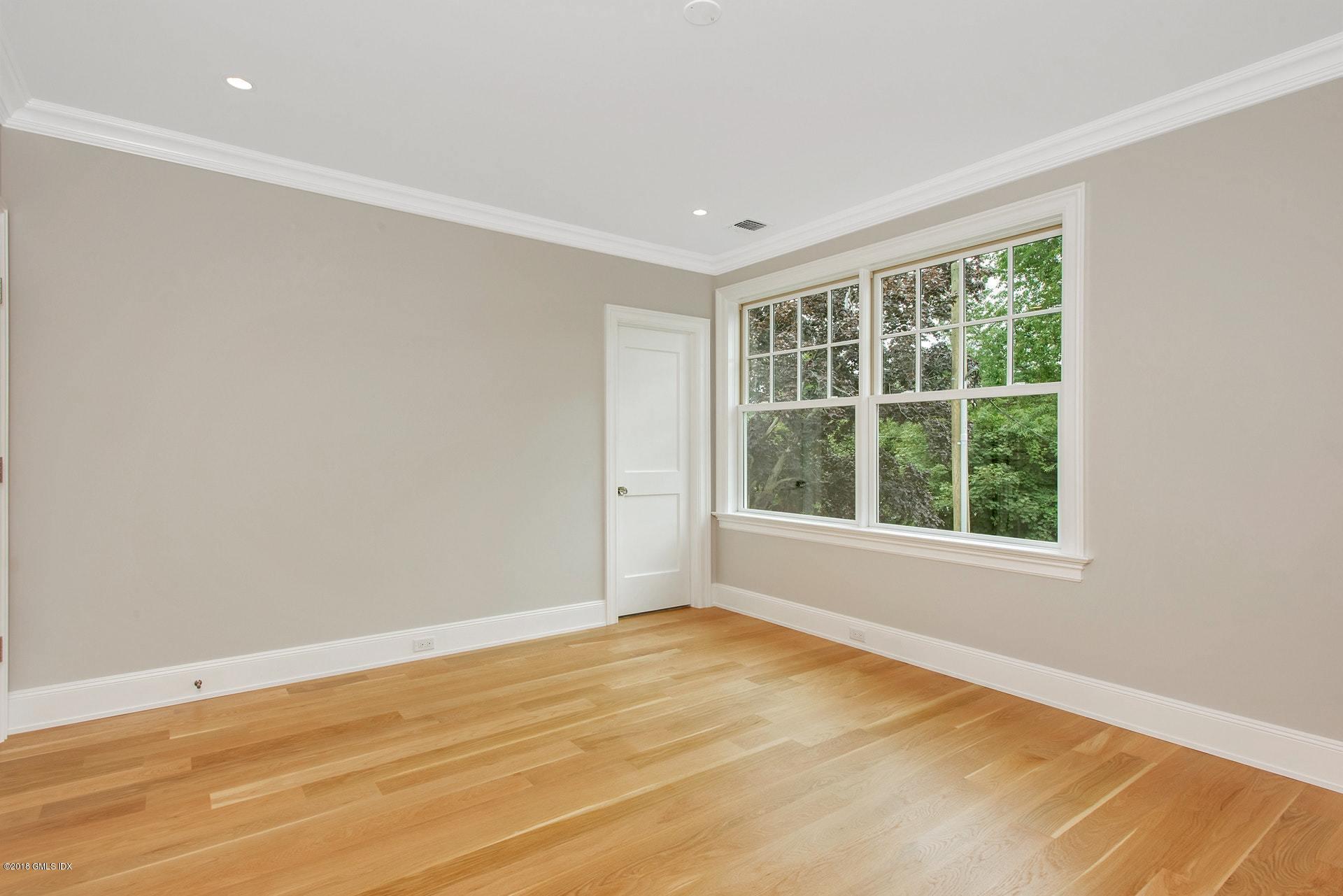 51 Sheep Hill Road Riverside, CT 06878 - Photo 19 of 36 a view of an empty room with wooden floor and a window
