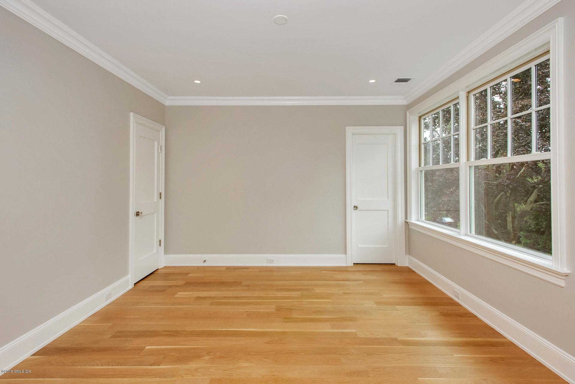 51 Sheep Hill Road Riverside, CT 06878 - Photo 20 of 36 a view of an empty room with wooden floor and a window