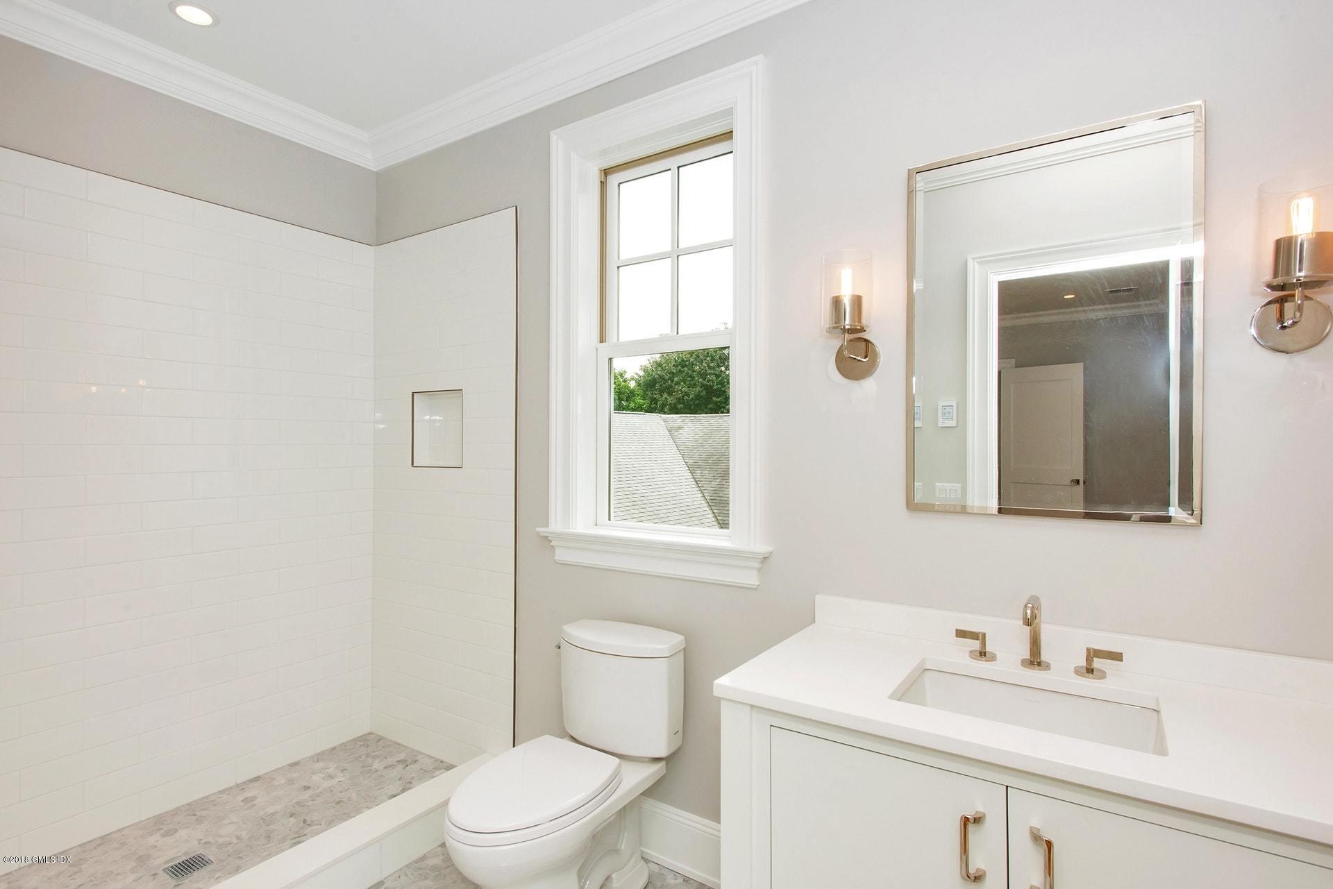 51 Sheep Hill Road Riverside, CT 06878 - Photo 21 of 36 a bathroom with a sink a toilet and a mirror