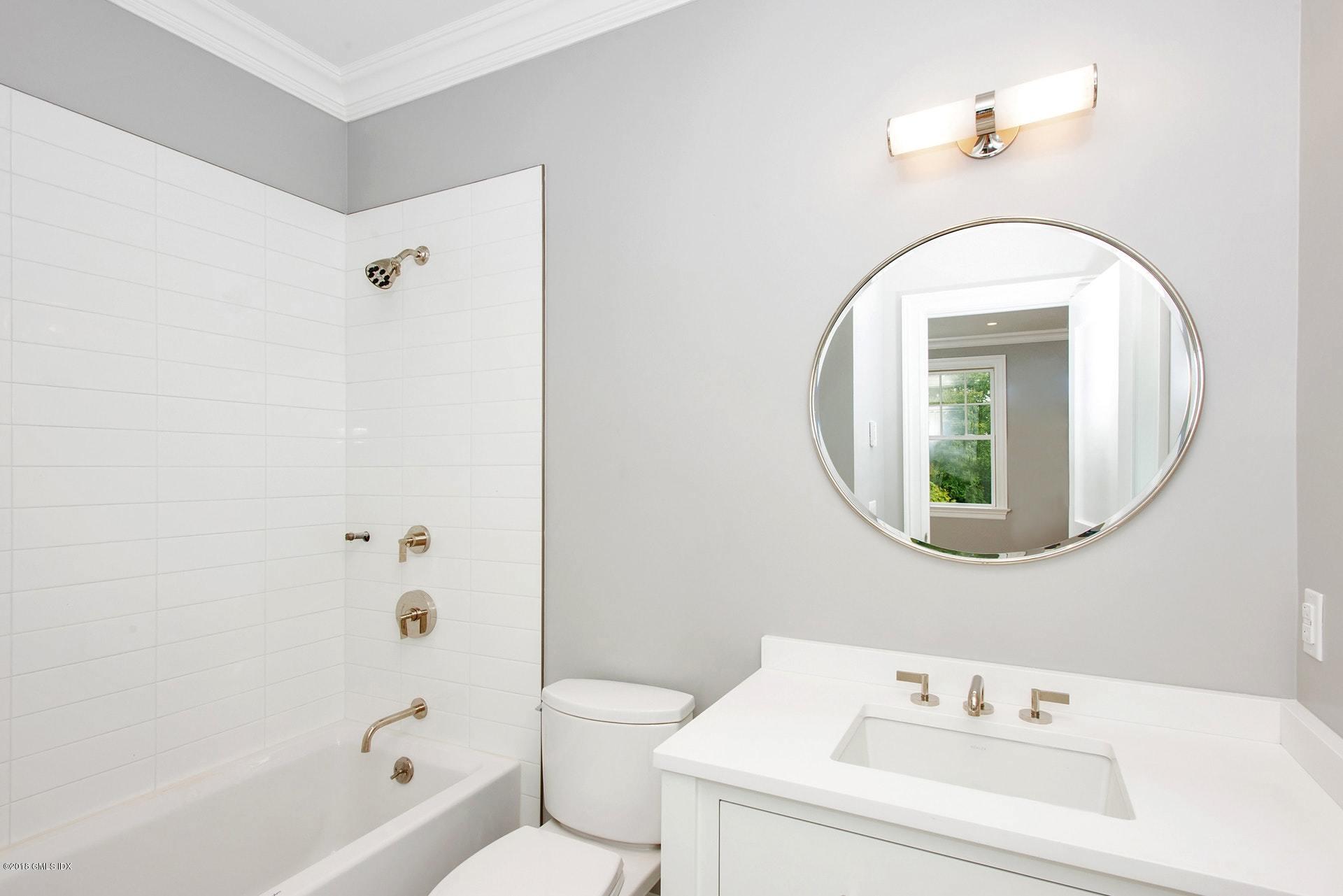 51 Sheep Hill Road Riverside, CT 06878 - Photo 23 of 36 a bathroom with a sink a toilet and a mirror