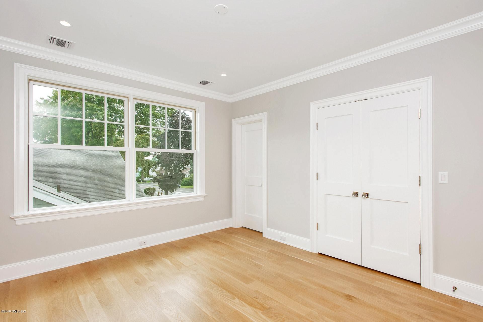 51 Sheep Hill Road Riverside, CT 06878 - Photo 24 of 36 an empty room with wooden floor and windows