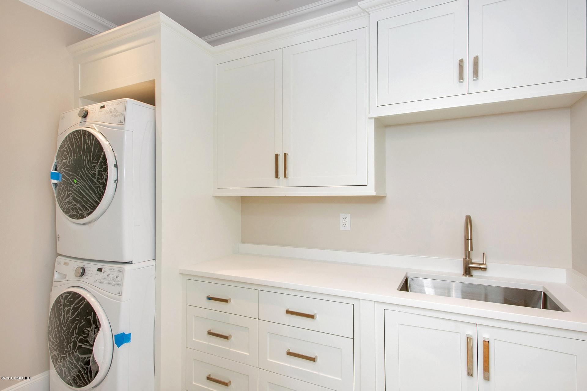 51 Sheep Hill Road Riverside, CT 06878 - Photo 29 of 36 a kitchen with a sink and a washer dryer