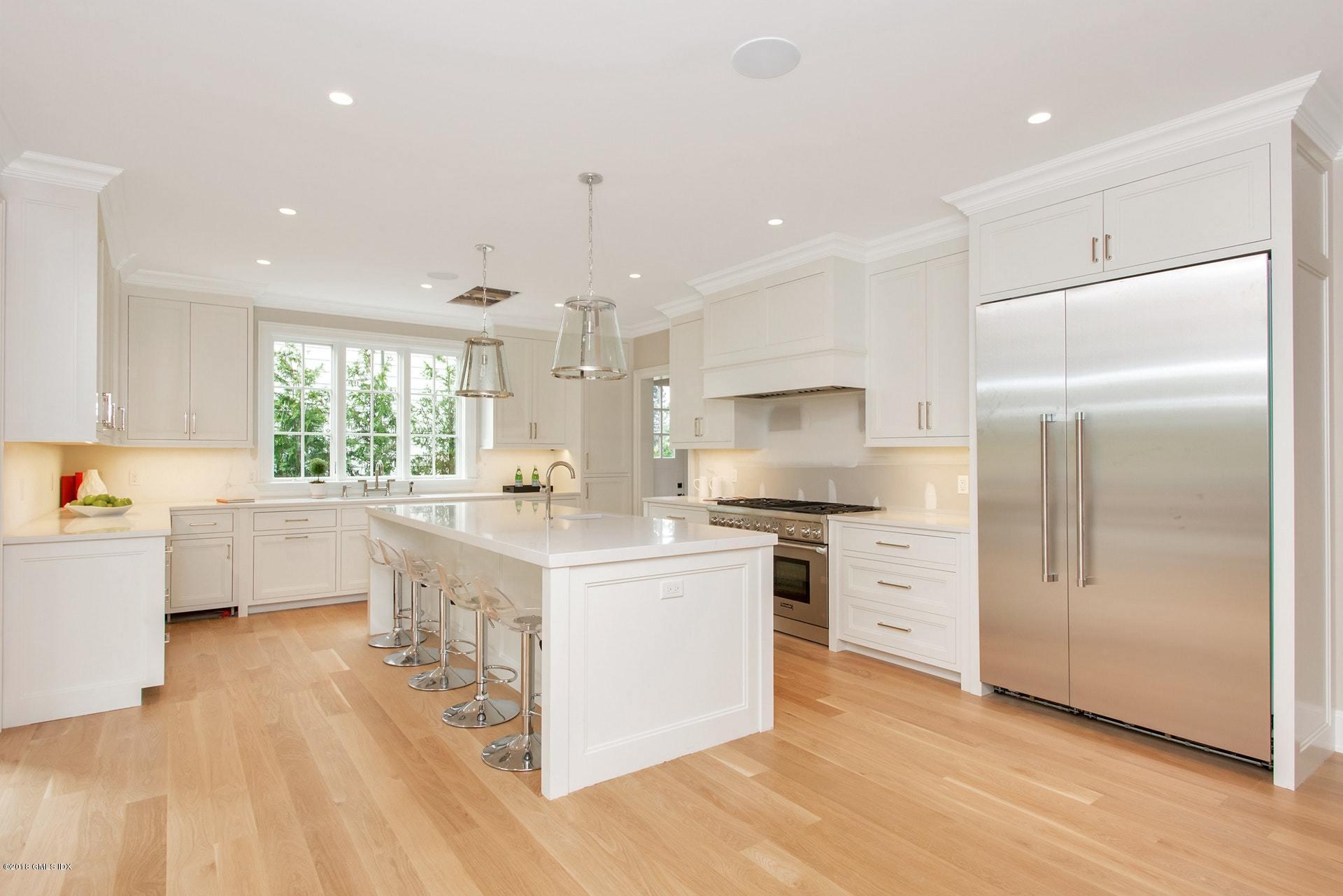 51 Sheep Hill Road Riverside, CT 06878 - Photo 10 of 36 a kitchen with stainless steel appliances a refrigerator a stove a sink cabinets and wooden floor
