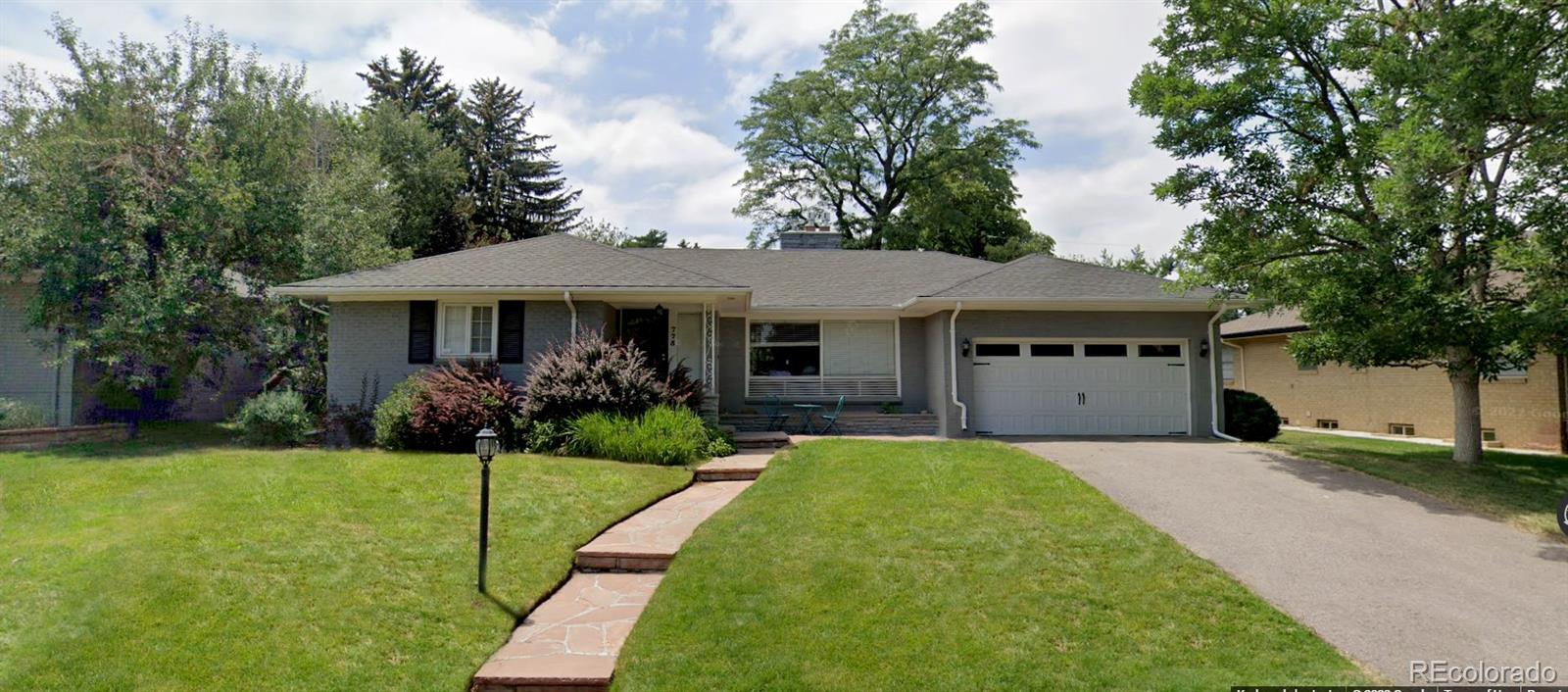 a front view of a house with garden