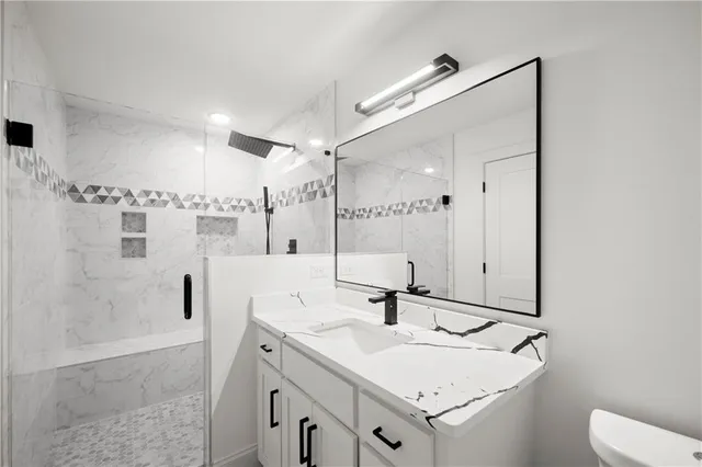 a bathroom with a sink toilet and shower