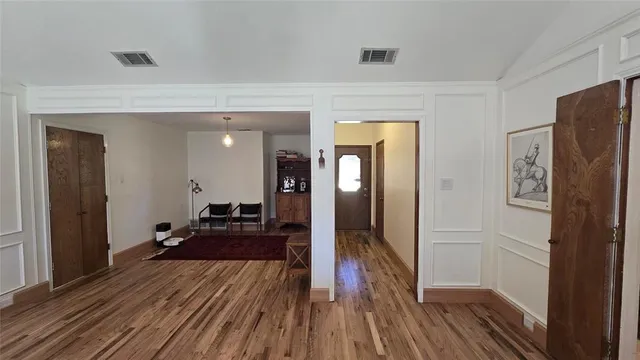 a view of a hallway view with wooden floor and furniture