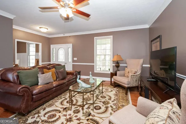 a living room with furniture and a flat screen tv