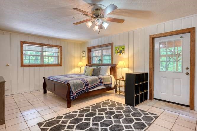 3333 Ellington Road Hayesville, NC 28904 - Photo 54 of 56 a bedroom with a bed and a chandelier