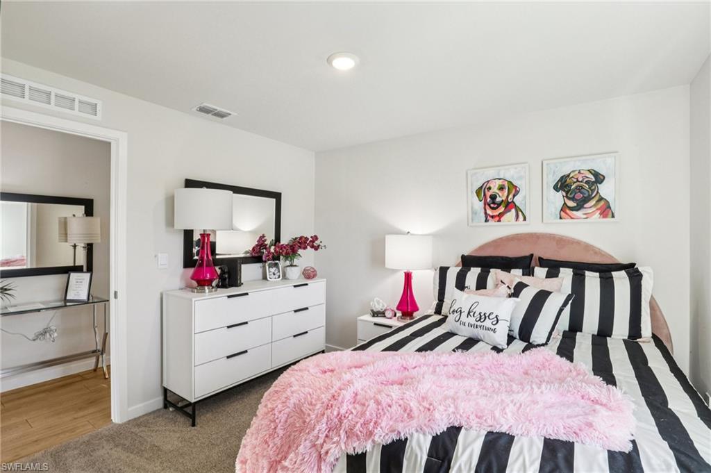 8052 Cedar Ky Way Lehigh Acres, FL 33971 - Photo 20 of 45 Model home. Bedroom featuring carpet and baseboards