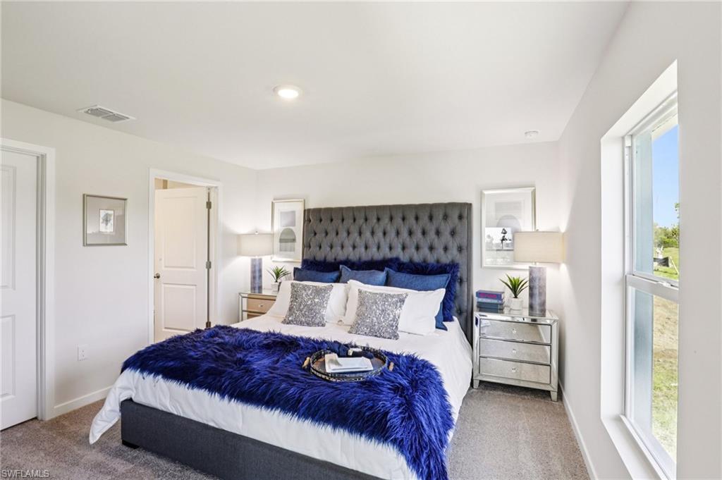 8052 Cedar Ky Way Lehigh Acres, FL 33971 - Photo 21 of 45 Model home. Carpeted bedroom featuring baseboards
