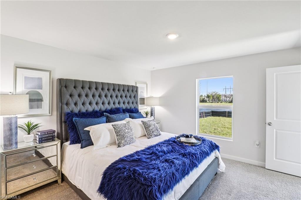 8052 Cedar Ky Way Lehigh Acres, FL 33971 - Photo 23 of 45 Model home. Carpeted bedroom featuring baseboards