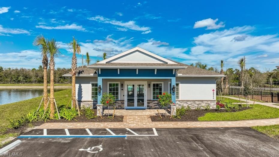 8052 Cedar Ky Way Lehigh Acres, FL 33971 - Photo 28 of 45 The property features a charming exterior with a gabled roof and a vibrant blue facade accent