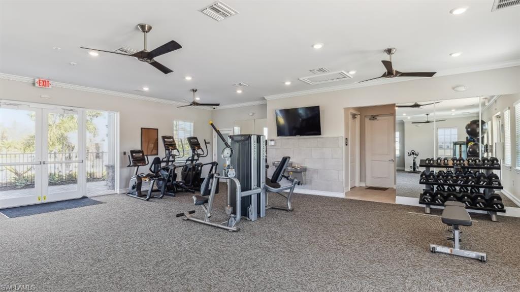 8052 Cedar Ky Way Lehigh Acres, FL 33971 - Photo 32 of 45 Well-appointed fitness area featuring a variety of exercise equipment, ceiling fans, and a mirrored wall