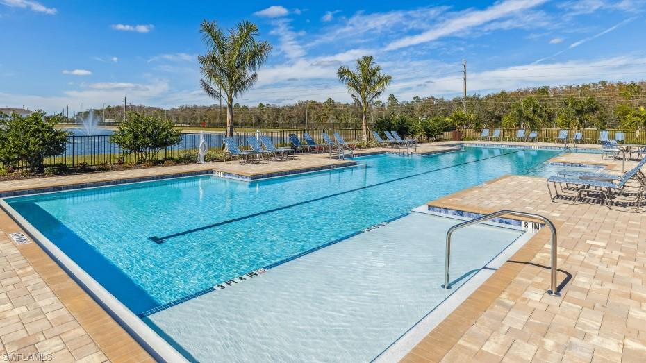 8052 Cedar Ky Way Lehigh Acres, FL 33971 - Photo 35 of 45 The community features a sparkling swimming pool with an integrated sun shelf, surrounded by a paver deck