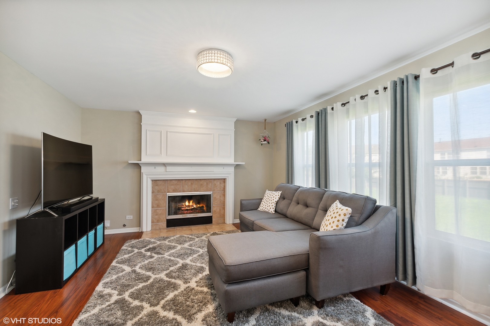 1769 Delta Drive Aurora, IL 60503 - Photo 4 of 14 a living room with furniture a flat screen tv and a fireplace