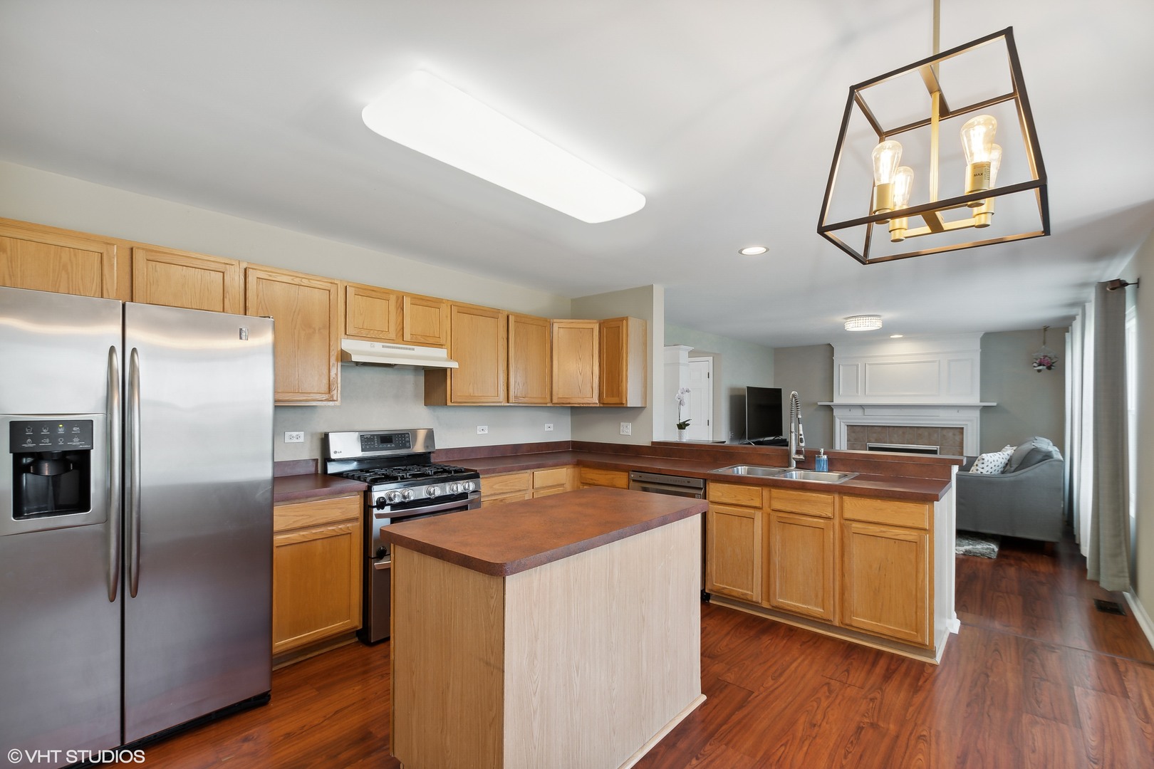 1769 Delta Drive Aurora, IL 60503 - Photo 6 of 14 a kitchen with stainless steel appliances a refrigerator a sink dishwasher a stove with wooden floor and cabinets