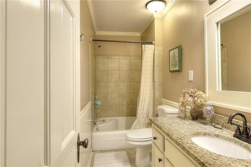 317 North Cherokee Road Social Circle, GA 30025 - Photo 23 of 32 a bathroom with a granite countertop sink toilet and shower