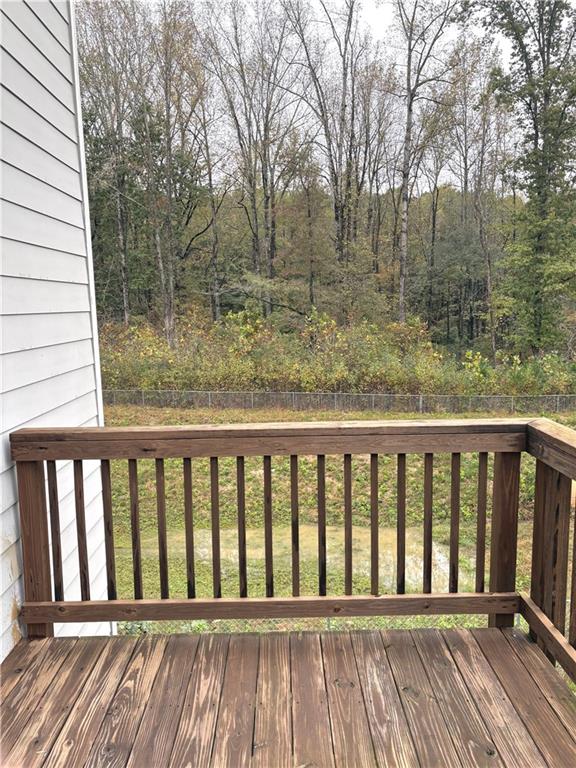 392 Katie Lane Commerce, GA 30529 - Photo 12 of 58 a balcony with wooden floor and fence