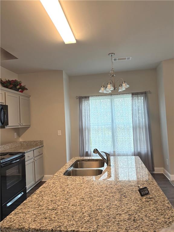 392 Katie Lane Commerce, GA 30529 - Photo 17 of 58 a view of a kitchen with a sink and chandelier