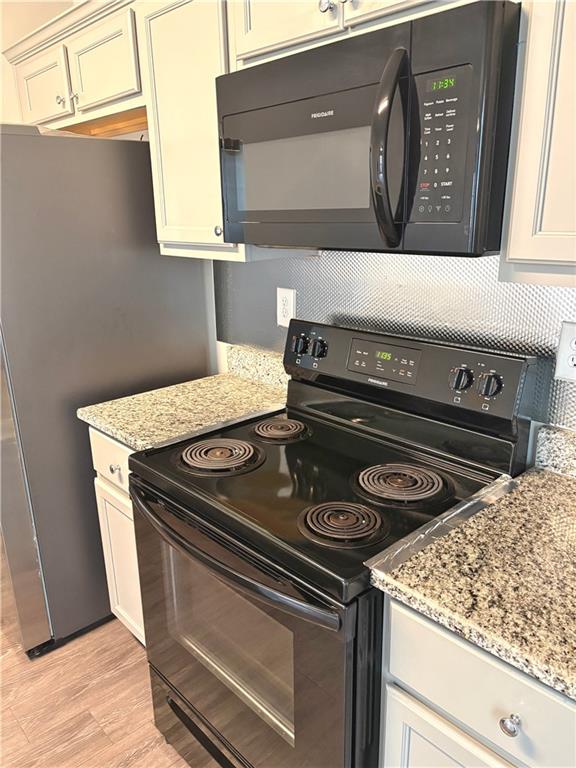 392 Katie Lane Commerce, GA 30529 - Photo 18 of 58 a stove top oven sitting inside of a kitchen