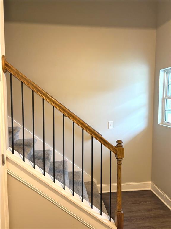 392 Katie Lane Commerce, GA 30529 - Photo 34 of 58 a view of staircase with wooden floor and fence