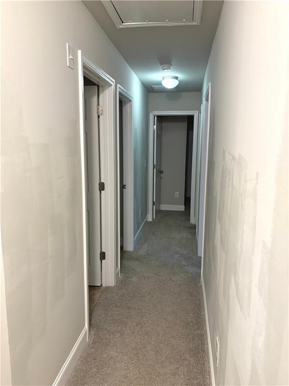 392 Katie Lane Commerce, GA 30529 - Photo 36 of 58 a view of a hallway with wooden shelves
