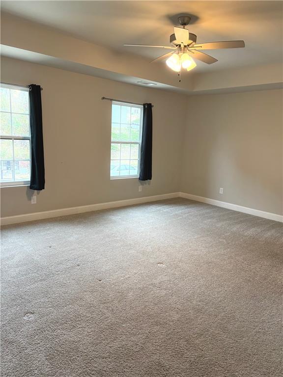 392 Katie Lane Commerce, GA 30529 - Photo 42 of 58 an empty room with a window and a ceiling fan