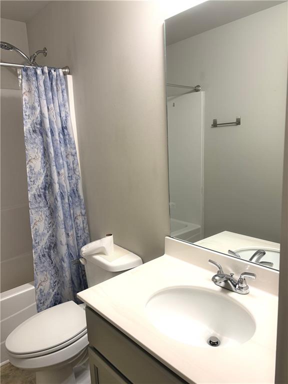 392 Katie Lane Commerce, GA 30529 - Photo 53 of 58 a bathroom with a sink a toilet and shower curtain