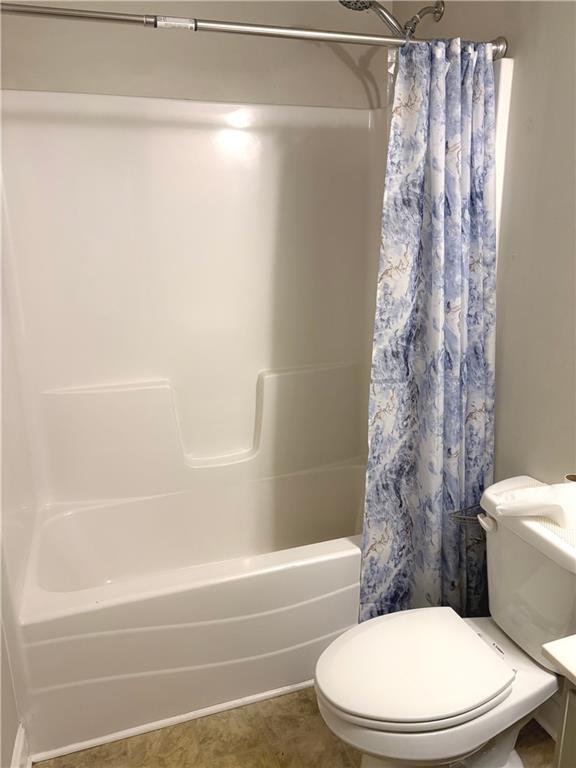 392 Katie Lane Commerce, GA 30529 - Photo 54 of 58 a white toilet and tub sitting next to a window