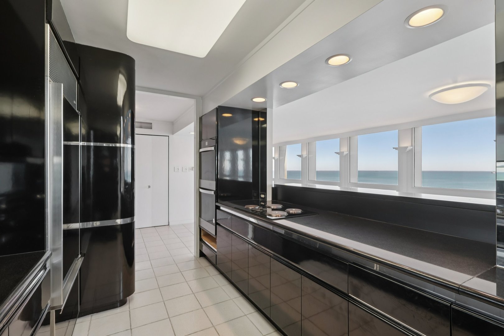 1240 North Lake Shore Drive, Unit 14A Chicago, IL 60610 - Photo 11 of 43 a kitchen with granite countertop a refrigerator and a stove top oven