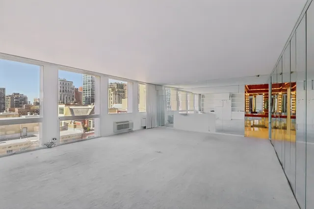 a big room with closet and windows