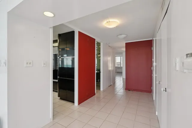 a view of an empty room and kitchen