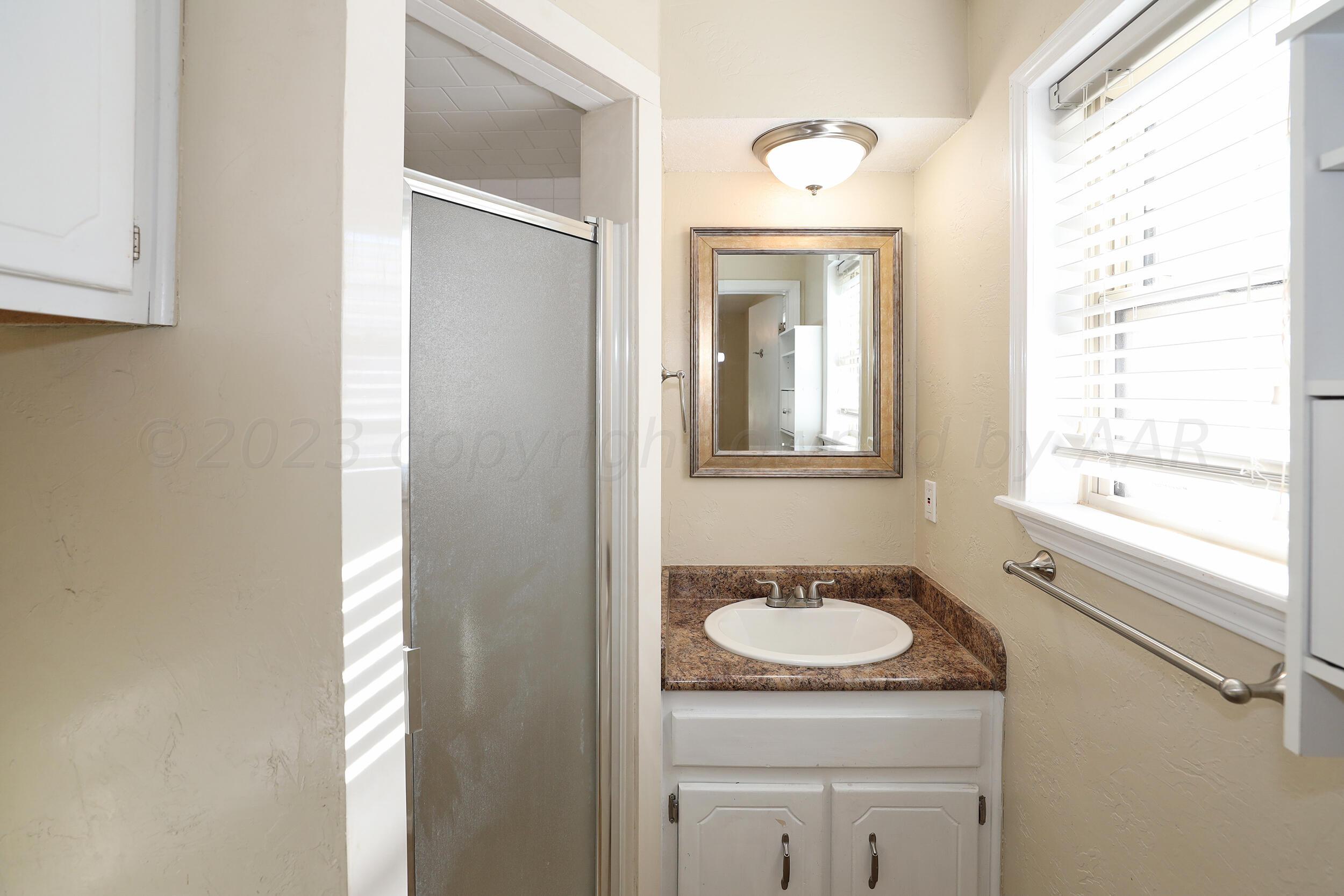 2905 Salem Drive Amarillo, TX 79110 - Photo 18 of 29 a bathroom with a granite countertop sink and a mirror