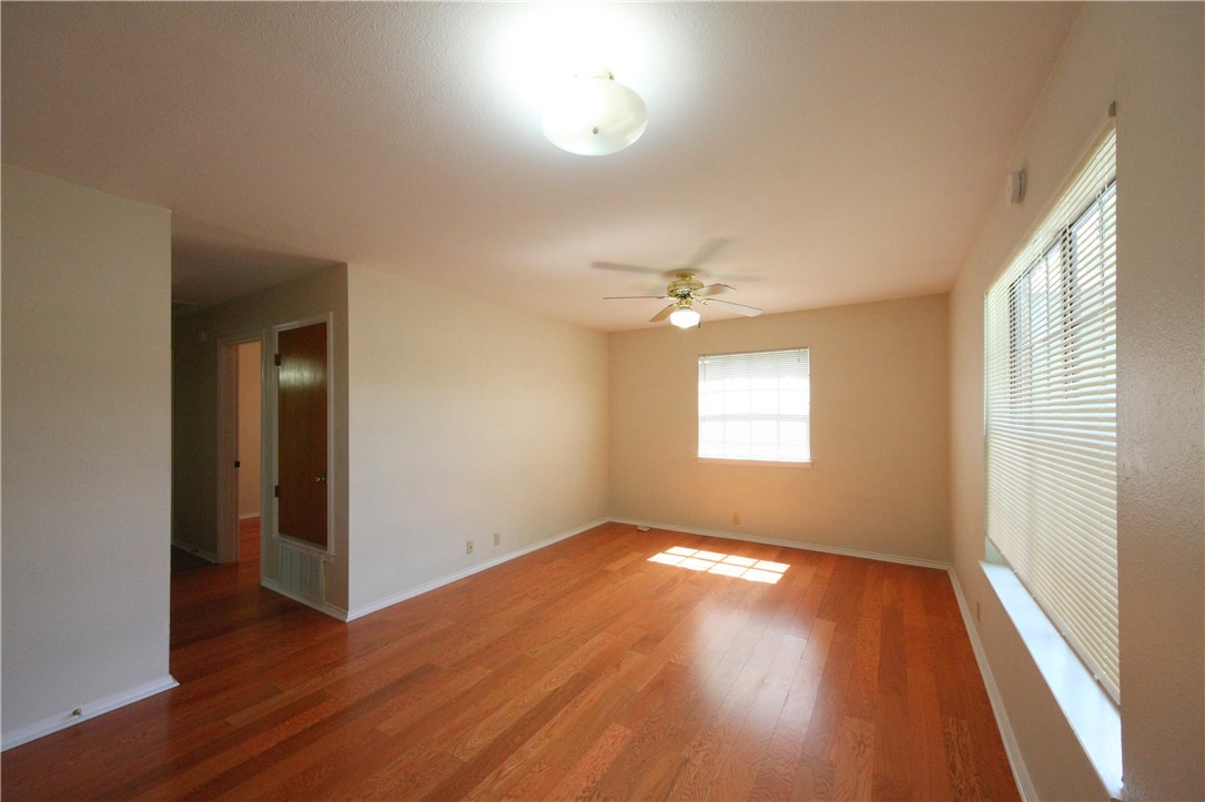 1903 East 20th Street, Unit 302 Austin, TX 78722 - Photo 2 of 11 an empty room with wooden floor and windows