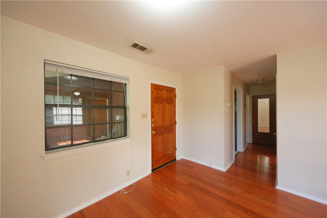 1903 East 20th Street, Unit 302 Austin, TX 78722 - Photo 3 of 11 a view of an empty room with wooden floor and a window