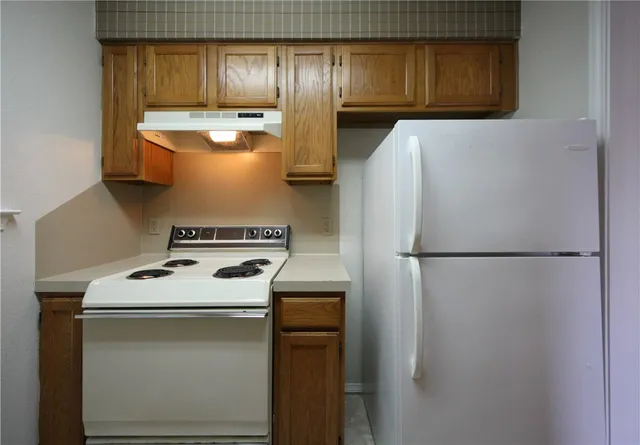 a white refrigerator freezer sitting inside of a kitchen