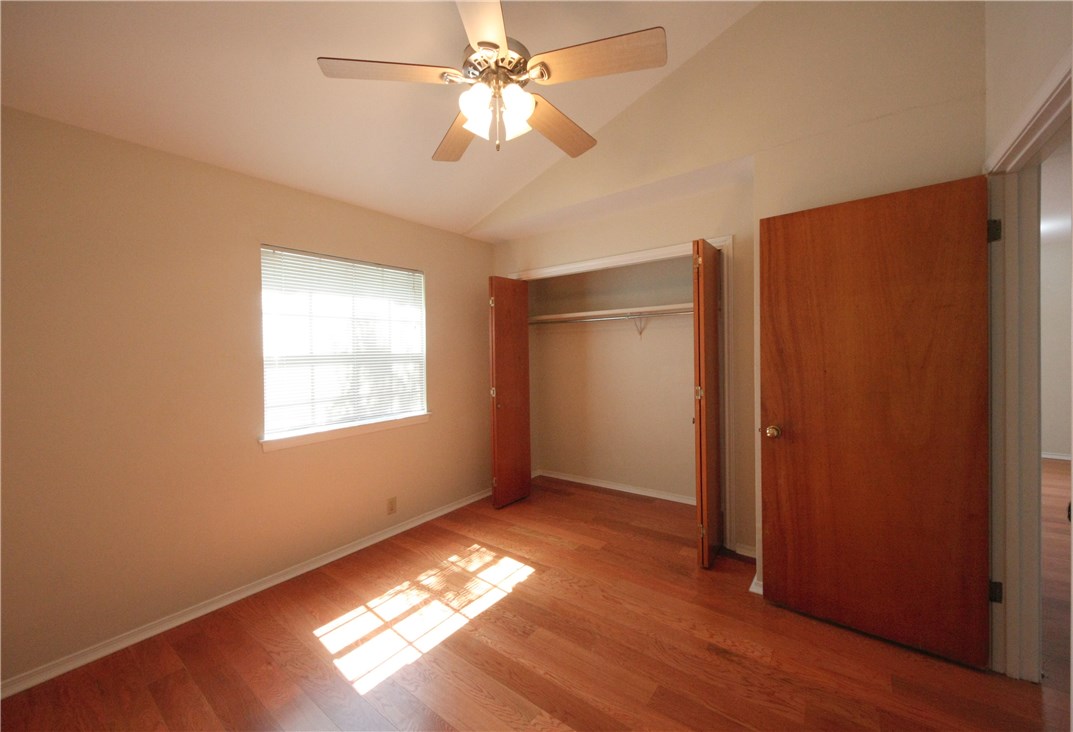 1903 East 20th Street, Unit 302 Austin, TX 78722 - Photo 6 of 11 wooden floor in an empty room with a window