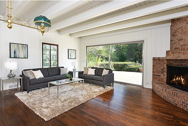 115 Woodley Road Winnetka, IL 60093 - Photo 22 of 41 a living room with furniture and a fireplace