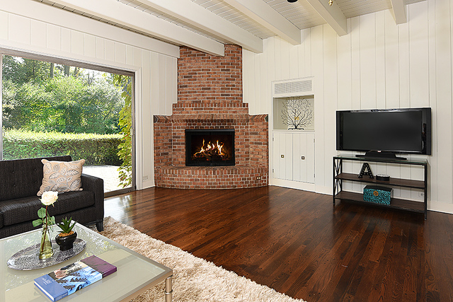 115 Woodley Road Winnetka, IL 60093 - Photo 23 of 41 a living room with furniture fireplace and a flat screen tv
