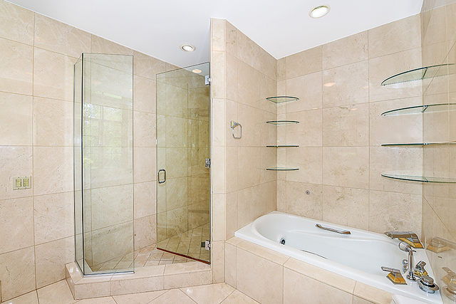 115 Woodley Road Winnetka, IL 60093 - Photo 29 of 41 a bathroom with a tub shower and sink