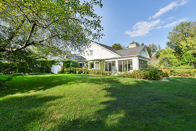 115 Woodley Road Winnetka, IL 60093 - Photo 36 of 41 a front view of a house with a garden