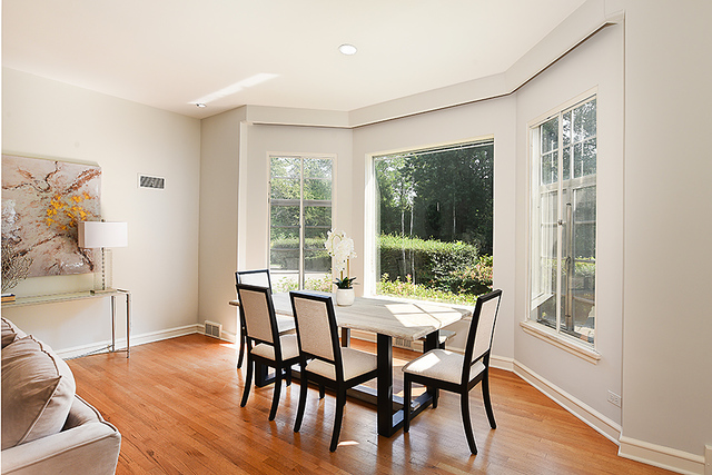 115 Woodley Road Winnetka, IL 60093 - Photo 7 of 41 a view of a dining room with furniture window and wooden floor