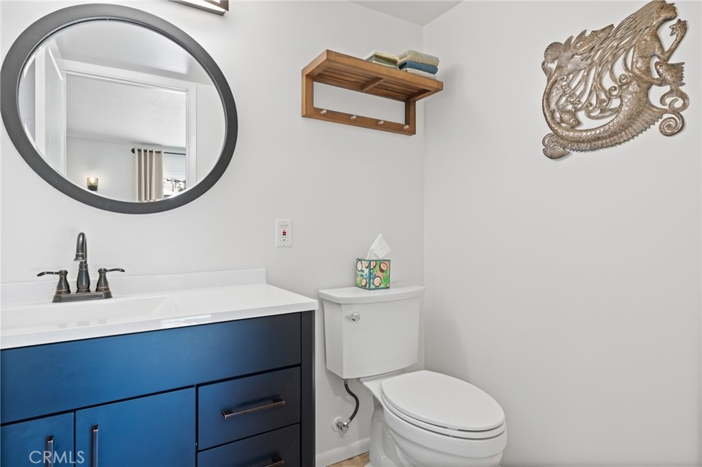 131 Gemini Street Lompoc, CA 93436 - Photo 13 of 30 a bathroom with a toilet a sink and a mirror