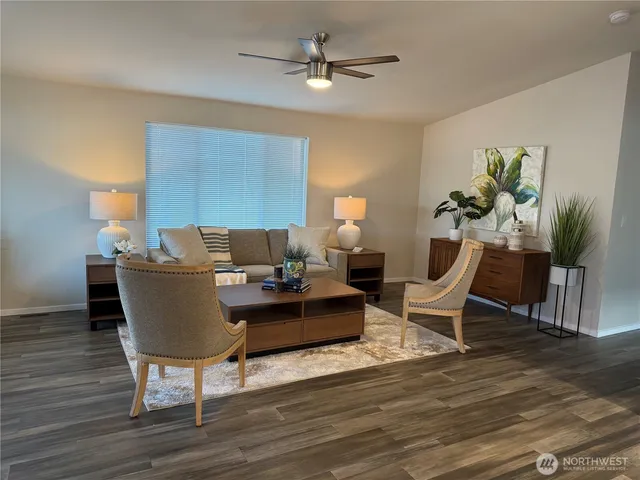 a living room with furniture and a wooden floor