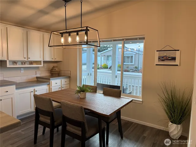 a view of a dining table chairs and chandelier