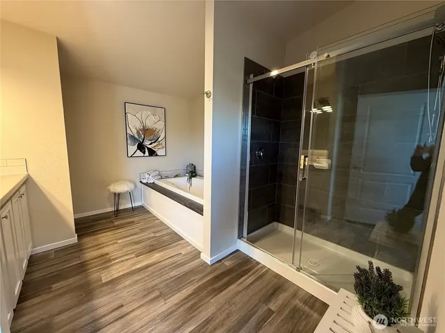 a bathroom with a bathtub and a shower