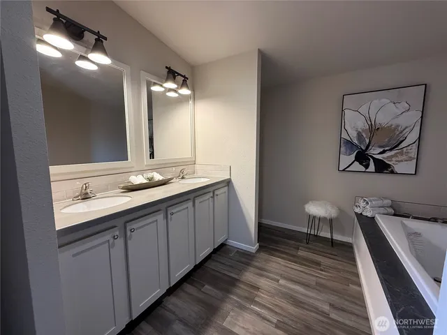 a spacious bathroom with a double vanity sink and a mirror