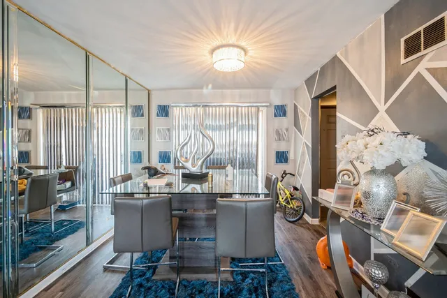 a living room with fireplace furniture and a large window