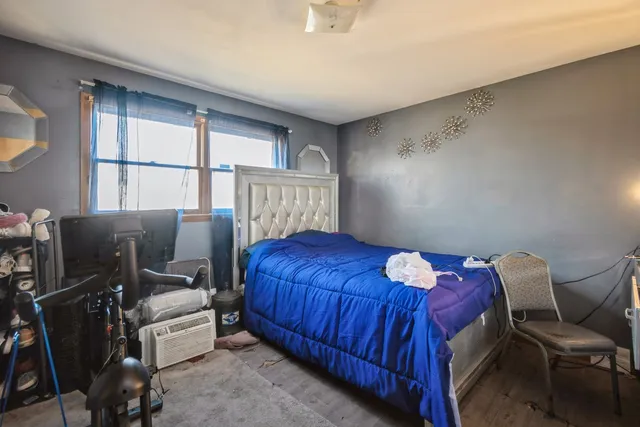 a bed sitting in a room next to a window